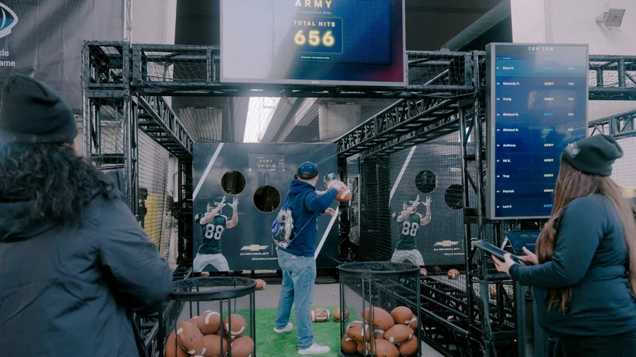 Chevrolet football toss cage at the Army-Navy game with live scoreboard and leaderboard